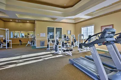 a fitness room with treadmills and tread machines at Lake-View Condo with Pool Access 6 Mi to Disney! in Kissimmee