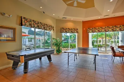 a large room with two ping pong tables in it at Lake-View Condo with Pool Access 6 Mi to Disney! in Kissimmee