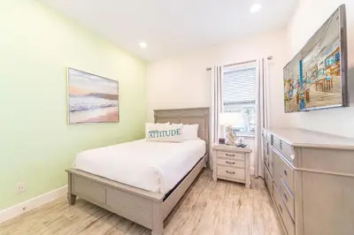 a bedroom with a bed and a dresser and a window at Charming Cottage 3 Miles From Disney With Margaritaville Resort & Island H2O Access - 8083Kd in Orlando