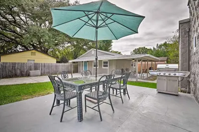 a table with chairs and an umbrella on a patio at Walk to Dtwn Winter Garden Home with Patio in Orlando