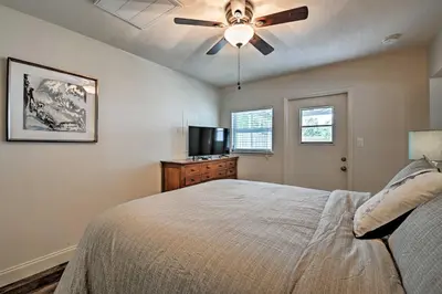 a bedroom with a bed and a ceiling fan at Walkable Winter Garden Bungalow 3 Blocks to Dtwn in Orlando