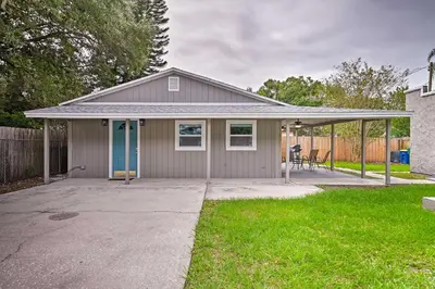 a house with a garage with a driveway at Walkable Winter Garden Bungalow 3 Blocks to Dtwn in Orlando