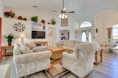 a living room with couches and a table at 12 Mi to Disney Home with Pool and Spa in Clermont in Orlando
