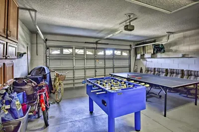 a garage with a ping pong table and a ping pong ball at 12 Mi to Disney Home with Pool and Spa in Clermont in Orlando