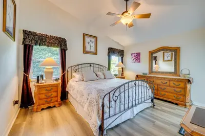 a bedroom with a bed and a dresser and a mirror at 12 Mi to Disney Home with Pool and Spa in Clermont in Orlando