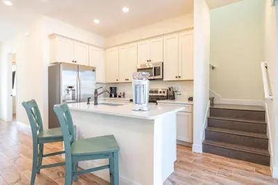 a kitchen with a counter with two chairs and a blender at Darling Five Bedroom Cottage Near Disney With Margaritaville Resort & Island H20 Waterpark Access - 2974La in Orlando