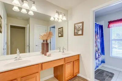 a bathroom with a sink and a mirror at 3 Mi to WDW Windsor Hills Home with Game Room! in Orlando