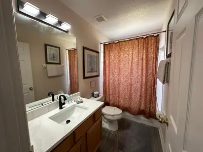 a bathroom with a sink and a toilet at 7 Bedroom, 6 bath and pool near Disney in Emerald Island 4 King Master Suites in Kissimmee