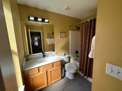 a bathroom with a sink and a toilet and a mirror at 7 Bedroom, 6 bath and pool near Disney in Emerald Island 4 King Master Suites in Kissimmee