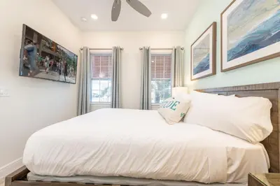 a bedroom with a white bed and two windows at Blue Cascade Cottage Near Disney With Margaritaville Resort & Island H2O Access - 8064Ls in Orlando