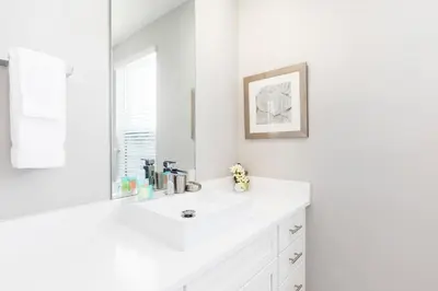 a white bathroom with a sink and a mirror at Cozy Villa 5 Min to Disney w BBQ, SMV104 in Orlando