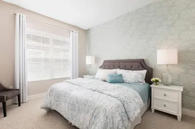 a bedroom with a large bed and a window at Comfy Villa 5 Min to Dinsey! Hot Tub & BBQ in Orlando