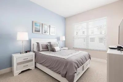 a white bedroom with a bed and a window at Amazing Family Villa 5min Disney w BBQ 128 in Orlando