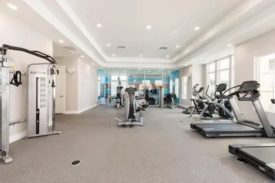 a gym with treadmills and cardio equipment in a building at Amazing Family Villa 5min Disney w BBQ 128 in Orlando