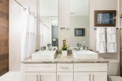 a bathroom with two sinks and a mirror at Precious Townhome w BBQ 131 in Orlando