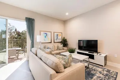 a living room with a couch and a tv at Fantastic Townhome 5min Disneyworld 134 in Orlando