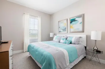 a white bedroom with a bed and a window at Fantastic Townhome 5min Disneyworld 134 in Orlando