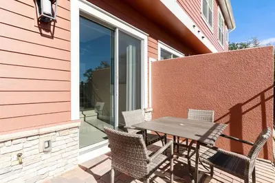 a patio with a table and chairs on a balcony at Fantastic Townhome 5min Disneyworld 134 in Orlando