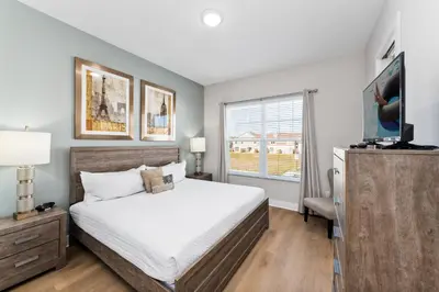 a bedroom with a bed and a television in it at 5min to Disney Spacious Family Villa SMV135 in Orlando