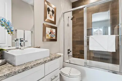 a bathroom with a sink and a toilet and a shower at 5min to Disney Spacious Family Villa SMV135 in Orlando