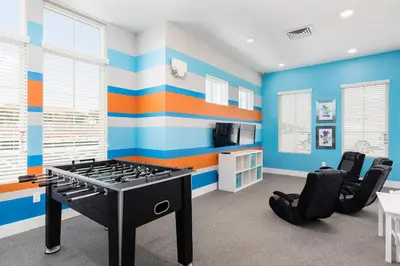 a blue and orange room with a ping pong table at Beautiful Family Villa Patio area with BBQ 5min Disney in Orlando