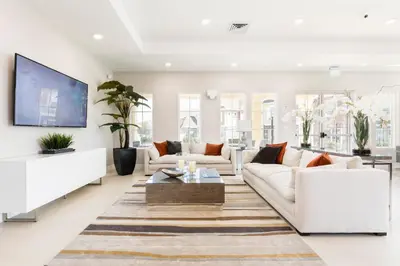 a living room with white furniture and a flat screen tv at Amazing Hidden Gem, Min Disney 139 in Orlando