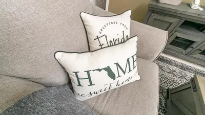 a pillow sitting on a couch with a heartbeatatch at Large 6BR Themed Family Villa Near Disney world in Kissimmee