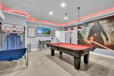 a room with a pool table and a movie poster at Large 6BR Themed Family Villa Near Disney world in Kissimmee