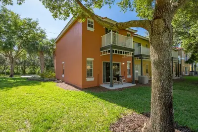 an exterior view of a house with a tree at Emerald Island-RU1029 in Kissimmee