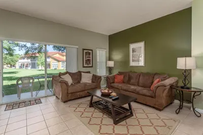 a living room with a couch and a table at Emerald Island-RU1029 in Kissimmee