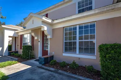 a house with a driveway in front of it at Windsor Palms-RU831 in Kissimmee