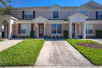 a house with a driveway in front of it at Windsor Palms-RU831 in Kissimmee