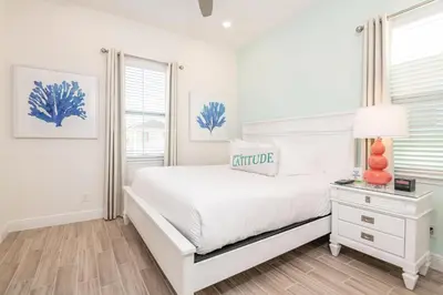 a white bedroom with a white bed and a window at Sea Breeze Cottage Near Disney With Margaritaville Resort & Island H20 Waterpark Access - 2982La in Orlando