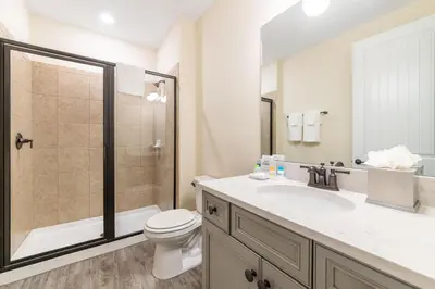 a bathroom with a toilet and a sink and a shower at Ocean Waves Cottage Near Disney With Margaritaville Resort & Island H20 Waterpark Access - 2983La in Orlando