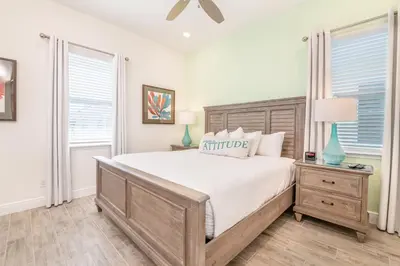 a bedroom with a large bed and two windows at Coral Reef Cottage! Near Disney With Margaritaville Resort & Island H2O Access - 8052Ls in Orlando