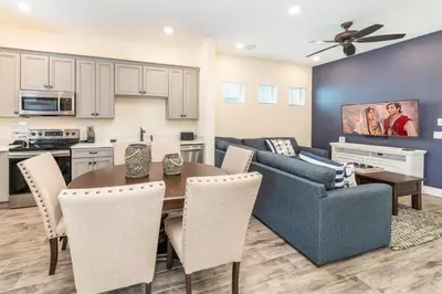 a kitchen and living room with a table and chairs at Smooth Sailing Cottage Near Disney With Margaritaville Resort & Island H20 Waterpark Access - 2978La in Orlando