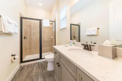 a bathroom with a toilet and a sink and a shower at Smooth Sailing Cottage Near Disney With Margaritaville Resort & Island H20 Waterpark Access - 2978La in Orlando