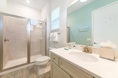 a bathroom with a toilet and a sink and a shower at Bright Cottage Near Disney With Margaritaville Resort & Island H2O Access - 8020Sb in Orlando