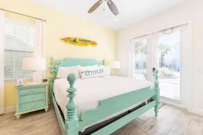 a bedroom with a blue bed and a nightstand at Bright Cottage Near Disney With Margaritaville Resort & Island H2O Access - 8020Sb in Orlando