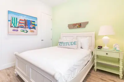a white bedroom with a white bed and a lamp at Bright Cottage Near Disney With Margaritaville Resort & Island H2O Access - 8020Sb in Orlando