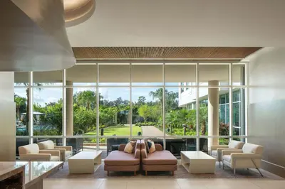 a living room with couches and a large window at The Celeste Hotel, Orlando, a Tribute Portfolio Hotel in Orlando