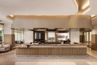 a lobby with a bar in a building at The Celeste Hotel, Orlando, a Tribute Portfolio Hotel in Orlando