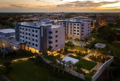 an aerial view of a building in a city at night at The Celeste Hotel, Orlando, a Tribute Portfolio Hotel in Orlando