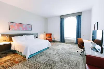 a hotel room with a bed and a desk at Hilton Garden Inn Winter Park, FL in Orlando