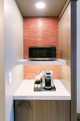 a kitchen with a microwave and a coffee maker on a counter at Hilton Garden Inn Winter Park, FL in Orlando