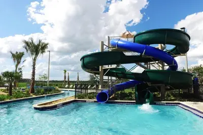 a water slide in a pool at a resort at Marvelous 2 Bd Apt Close to Disney at Storey Lake 106 in Kissimmee
