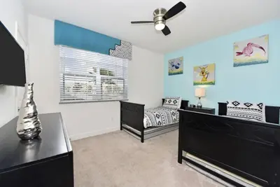 a bedroom with a bed and a ceiling fan at Beautiful 3-Bed Villa 10 Minutes From Disney-17440 Serenity Resort townhouse in Orlando