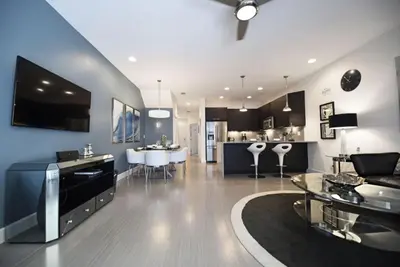 a living room with a couch and a dining room at Beautiful 3-Bed Villa 10 Minutes From Disney-17440 Serenity Resort townhouse in Orlando
