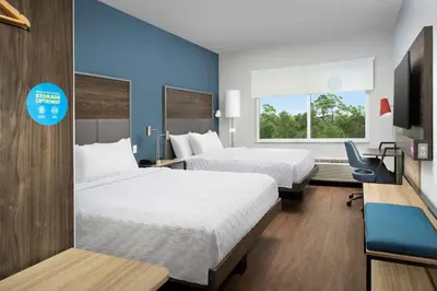 a hotel room with two beds and a tv at Tru By Hilton Orlando Convention Center in Orlando