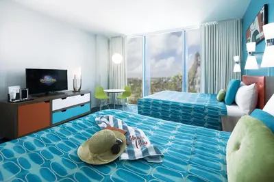 a child laying on a bed in a hotel room at Universal's Cabana Bay Beach Resort in Orlando